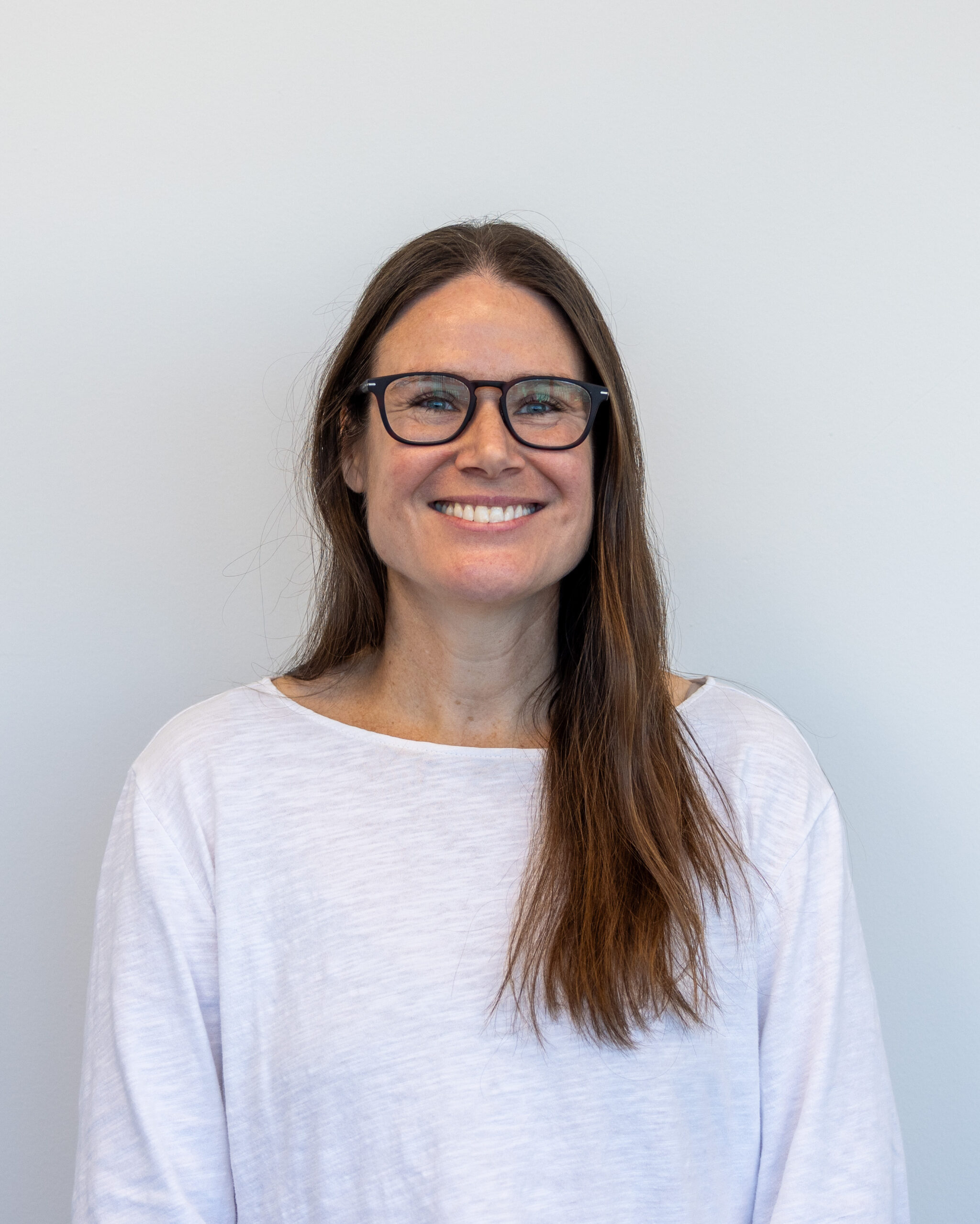 Image of woman with brown hair and glasses